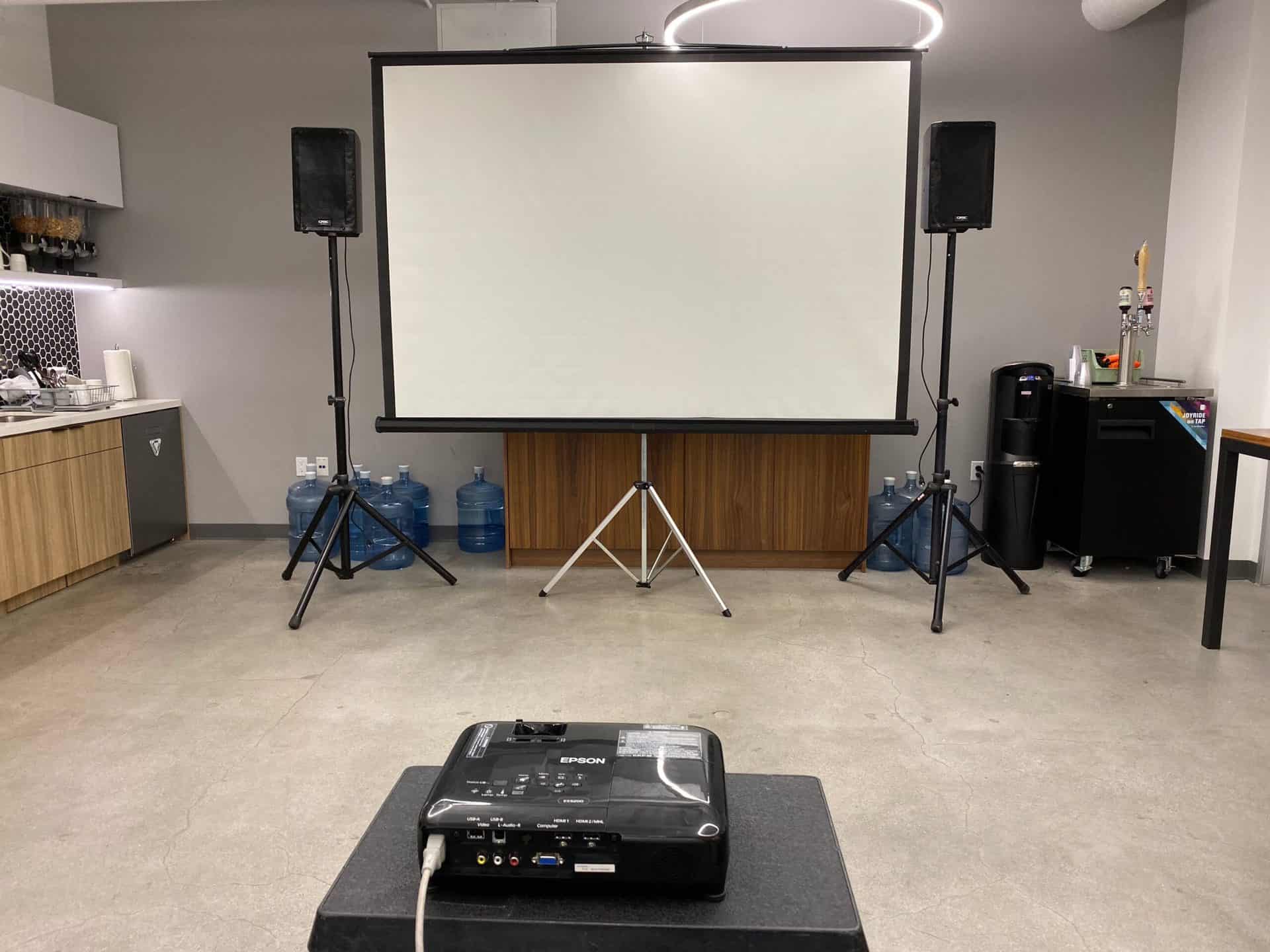 Projection screen and projector setup in a warehouse