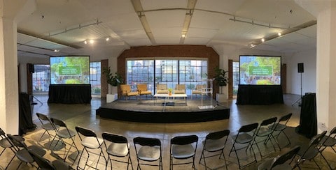Small stage with projection screens on either side