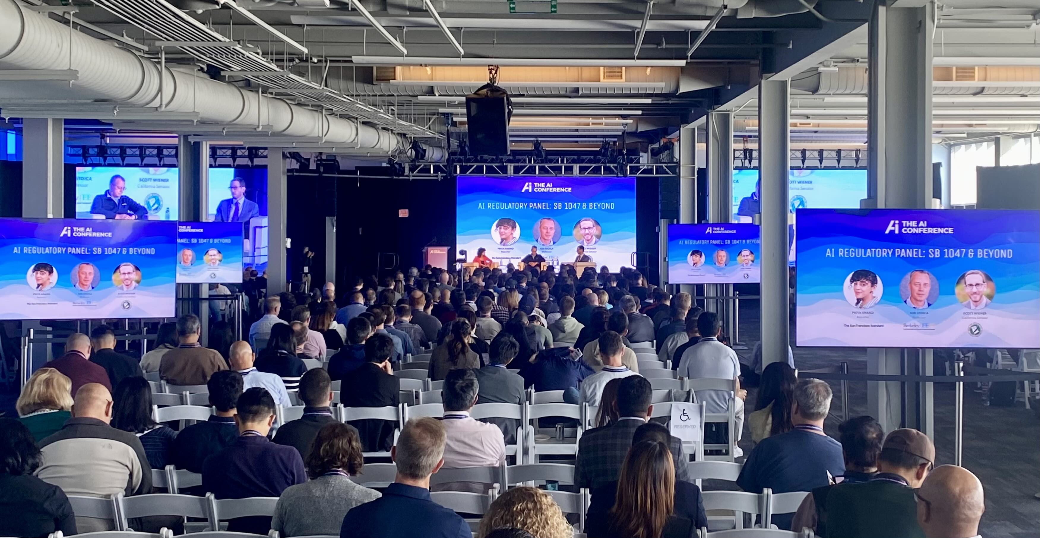 General session for a tech conference in San Francisco, with video walls and TV displays.