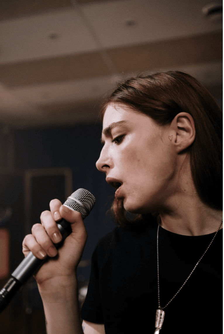 Woman singing into microphone