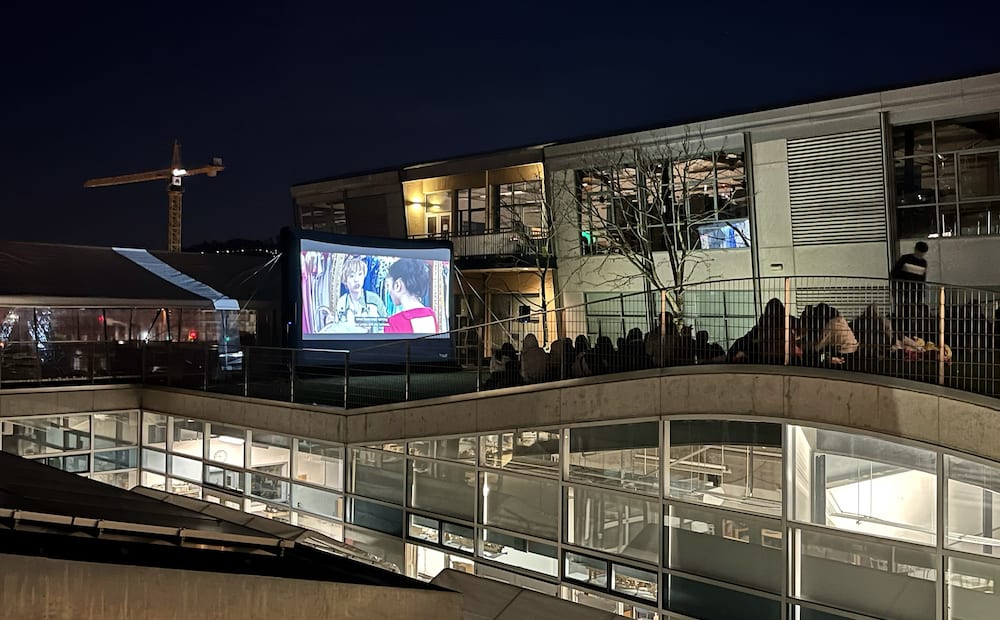 High school students watching outdoor movie