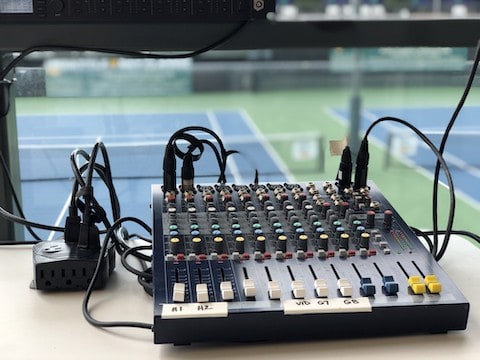 Audio mixer with tennis court in background