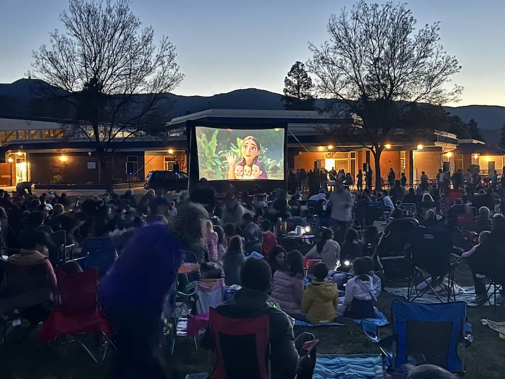 Kids watching an outdoor movie in San Jose