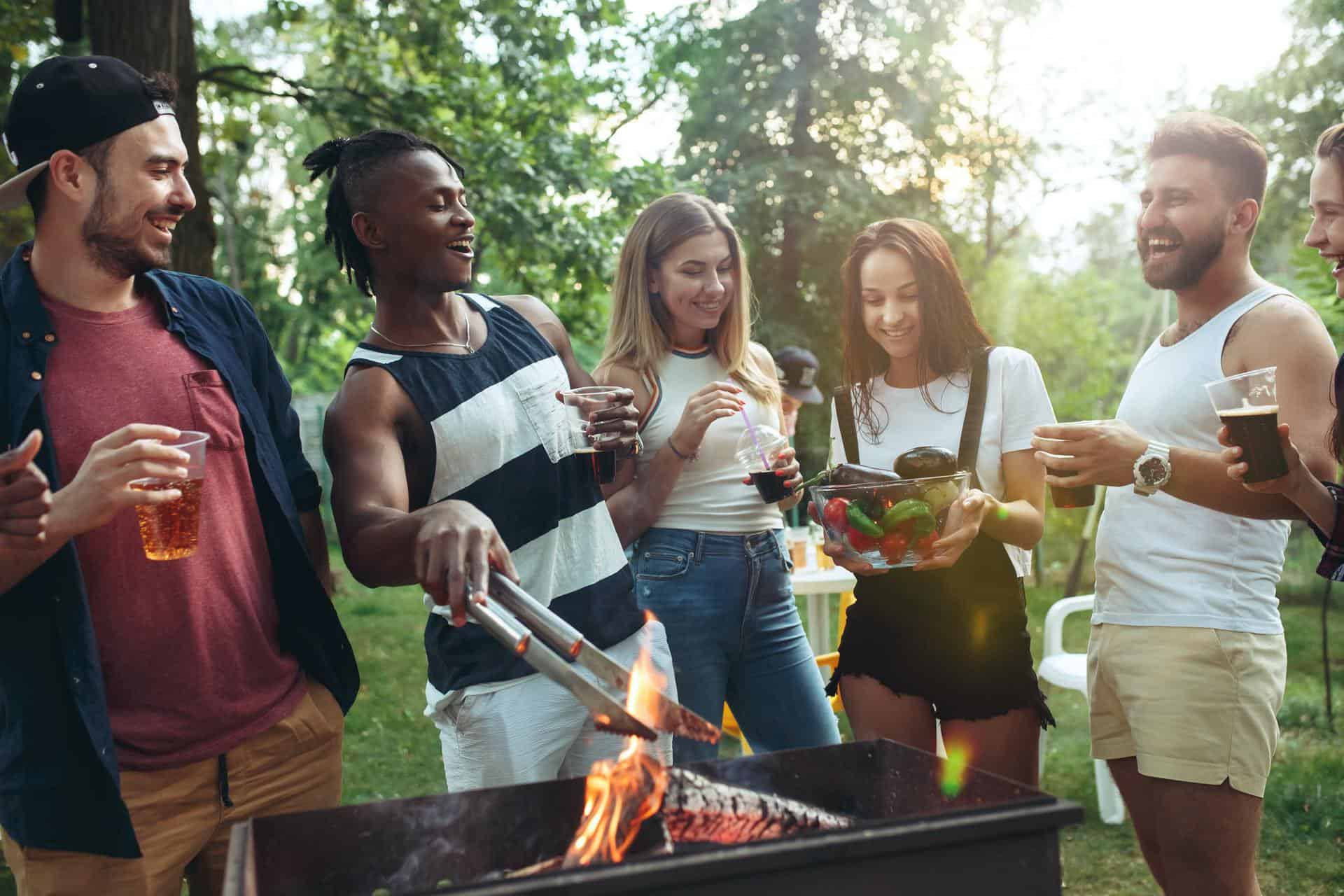 Group of friends making barbecue in the backyard. concept about good and positive mood with friends