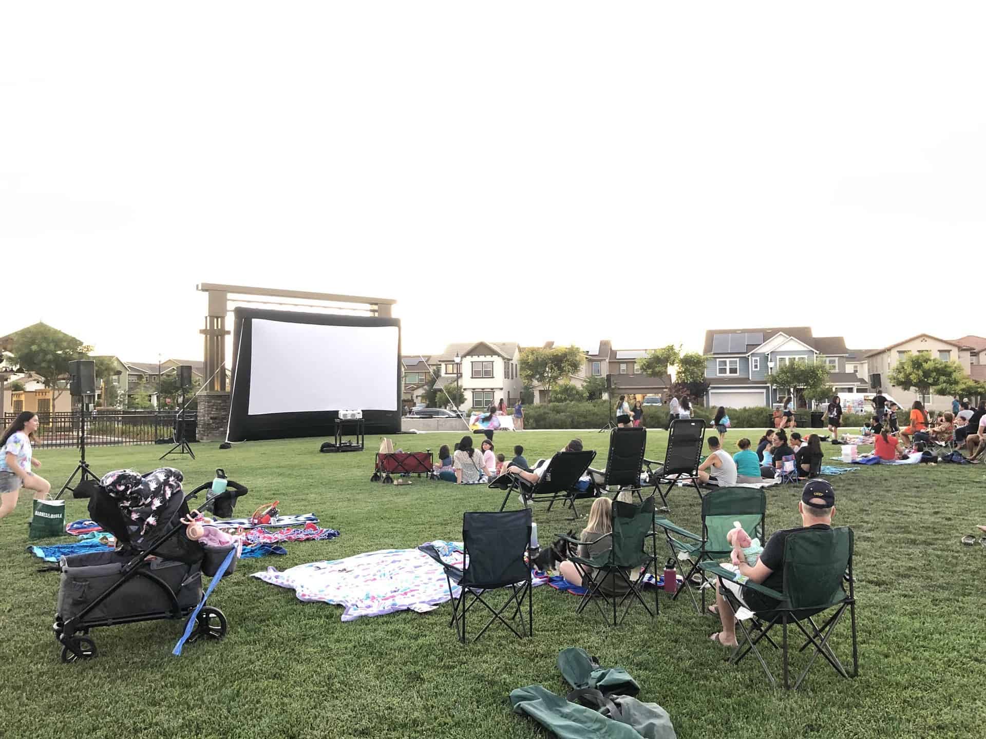 kids watching movie in park